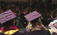 Over the shoulder view of crowd and graduation caps