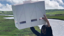 Photograph of Brenda Zhang holding a white box, which seems to be the mockup of a building