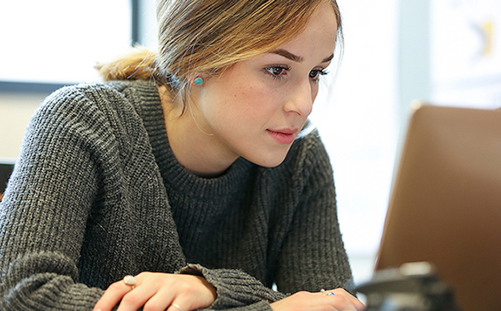 Close-up of female student looking at a laptop