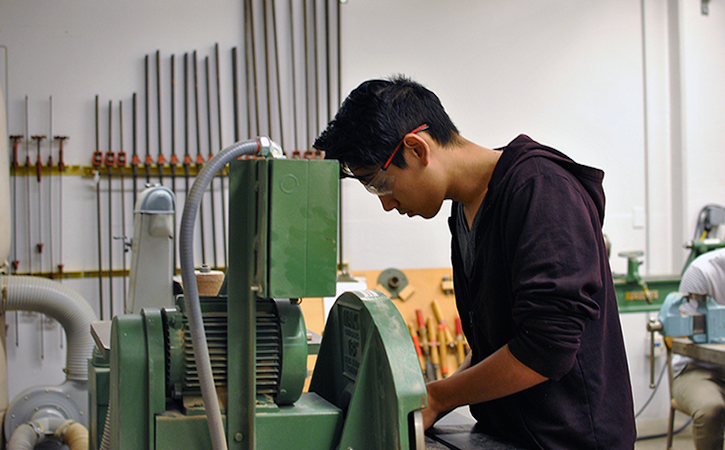 Industrial Design student working on a lathe machine