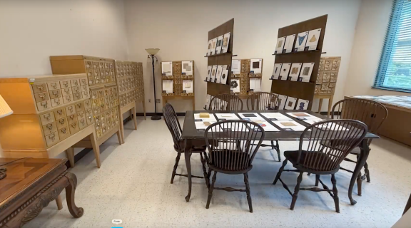 Photograph of the sustainable materials library. The photo shows a table with chairs, some drawer chests, and panels showcasing samples of sustainable materials.